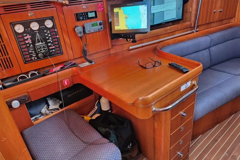 Slide: The Image of Navigation station in 2005 Elan 40 yacht with control panel and seating area. - 20
