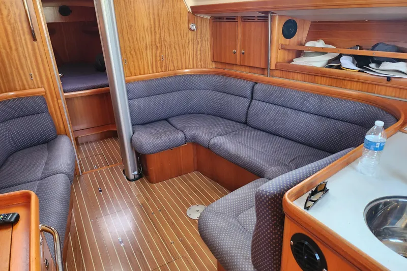 Slide: The Image of Interior of a 2005 Elan 40 yacht with cozy seating and wooden finishes. - 24
