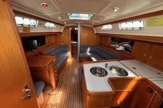 Slide: The Image of Interior of 2005 Elan 40 yacht with wood finish, seating, and kitchenette. - 25