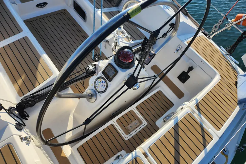 Slide: The Image of Cockpit of a 2005 Elan 40 sailboat with wooden deck and steering wheel. - 5