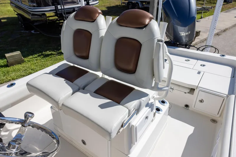Slide: The Image of 2018 Ranger 2510 Bay Ranger boat with dual cushioned seats and steering wheel. - 11