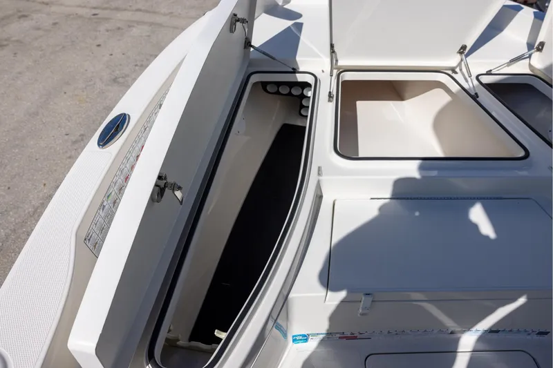 Slide: The Image of 2018 Ranger 2510 Bay Ranger boat storage compartments open on deck. - 15