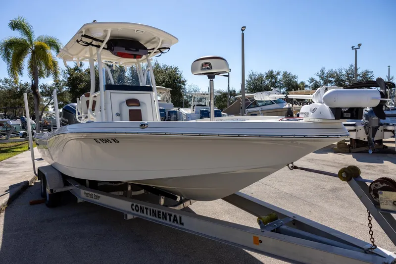 Slide: The Image of 2018 Ranger 2510 Bay Ranger boat on trailer, parked outdoors under clear sky. - 3