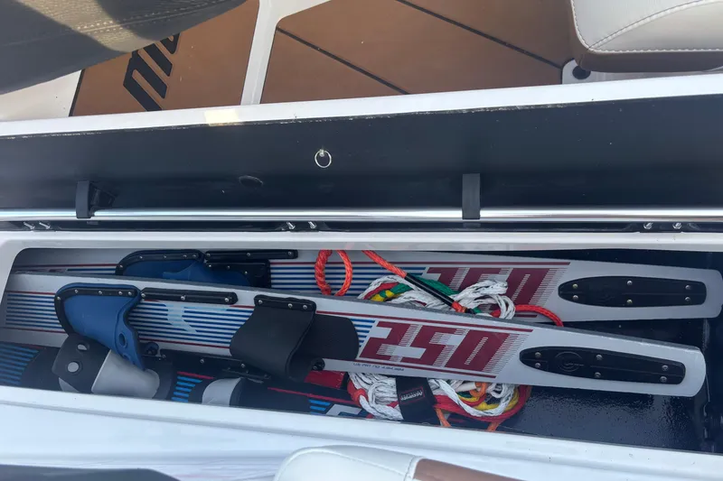 Slide: The Image of Storage compartment in 2025 Malibu Response TXi boat with water skis and ropes. - 16
