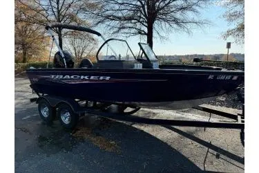 Slide: The Image of 2023 Tracker Pro Guide V-175 WT boat on trailer, parked outdoors. - 2