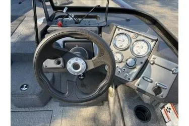 Slide: The Image of 2023 Tracker Pro Guide V-175 WT boat dashboard with steering wheel and gauges. - 4