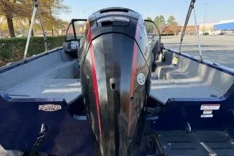 Slide: The Image of 2023 Tracker Pro Guide V-175 WT boat with powerful outboard motor in a parking lot. - 7
