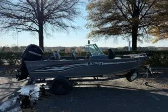 Slide: The Image of 2007 Lund 1775 Classic Sport boat on trailer, parked outdoors near trees. - 2