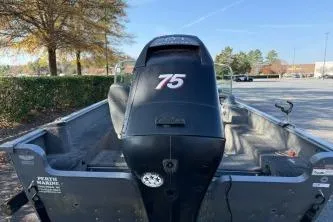 Slide: The Image of 2007 Lund 1775 Classic Sport boat with 75 HP motor in parking lot. - 6