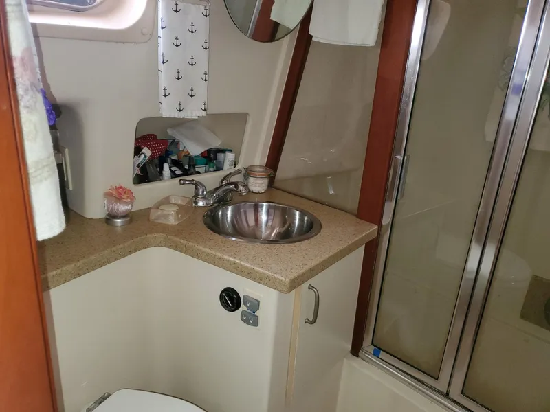Slide: The Image of Bathroom interior of 2007 Mainship 400 Trawler with sink, mirror, and shower. - 11