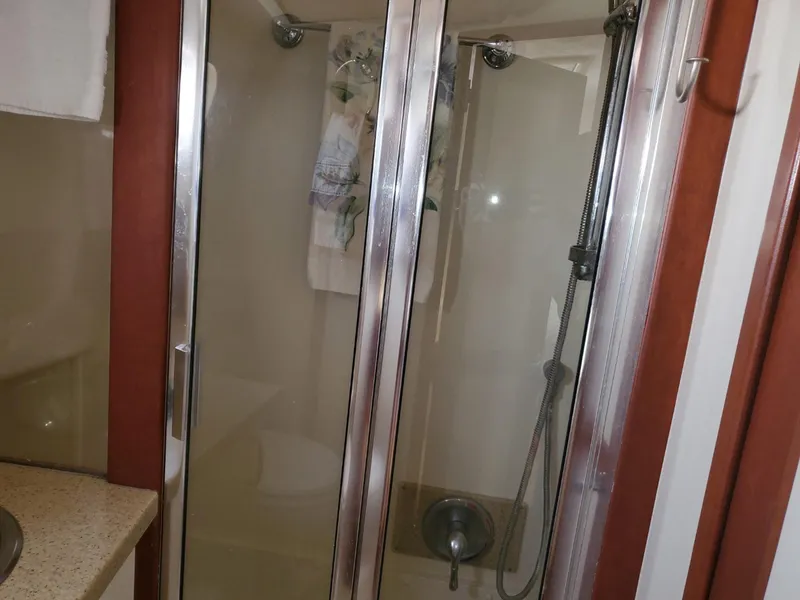 Slide: The Image of Shower area in 2007 Mainship 400 Trawler with glass doors and modern fixtures. - 12