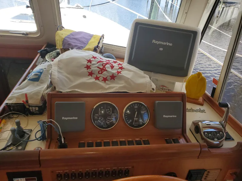Slide: The Image of 2007 Mainship 400 Trawler helm with Raymarine electronics and nautical equipment. - 13