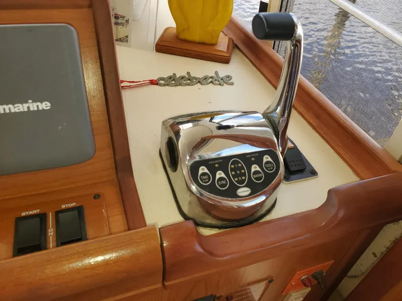 Slide: The Image of Control panel of a 2007 Mainship 400 Trawler with throttle lever and navigation equipment. - 14