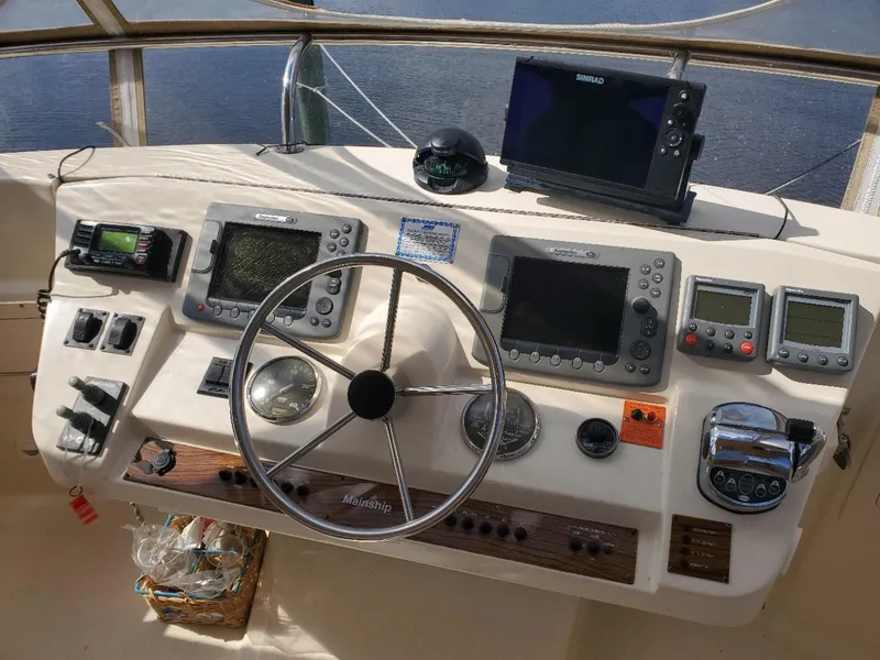 Slide: The Image of 2007 Mainship 400 Trawler helm with navigation instruments and steering wheel. - 16