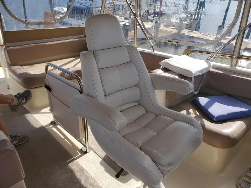 Slide: The Image of Captain's chair on 2007 Mainship 400 Trawler, with marina view in background. - 17