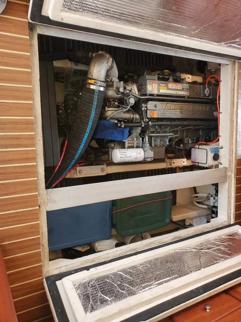 Slide: The Image of Engine compartment of a 2007 Mainship 400 Trawler, showcasing mechanical components and storage. - 20