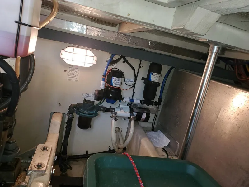 Slide: The Image of Engine room of 2007 Mainship 400 Trawler with visible mechanical components and wiring. - 22