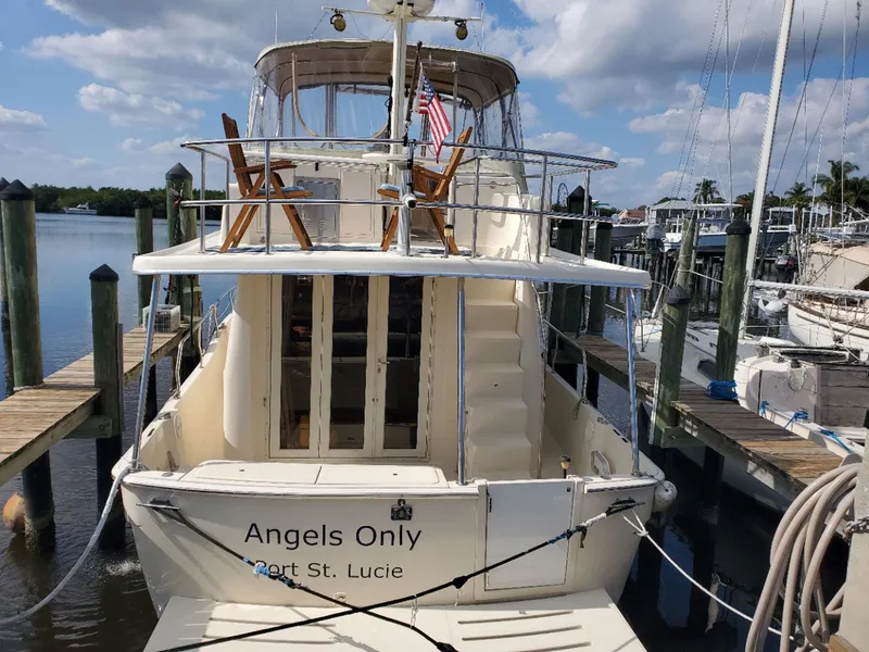 Slide: The Image of 2007 Mainship 400 Trawler docked, featuring "Angels Only" name and Port St. Lucie location. - 4