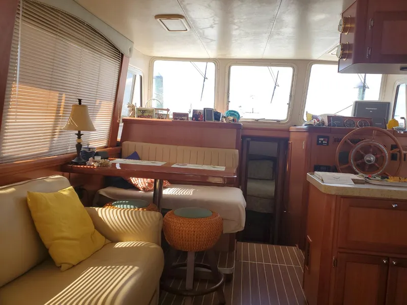 Slide: The Image of Interior of 2007 Mainship 400 Trawler with cozy seating and wooden accents. - 5