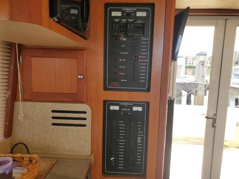 Slide: The Image of Electrical control panels inside a 2007 Mainship 400 Trawler boat cabin. - 7