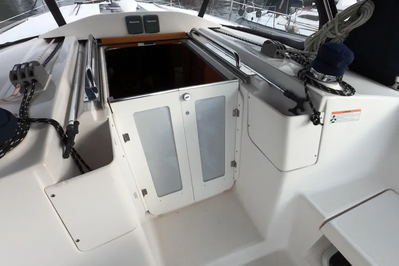 Slide: The Image of 2013 Marlow-Hunter e33 sailboat cockpit with open cabin doors. - 12