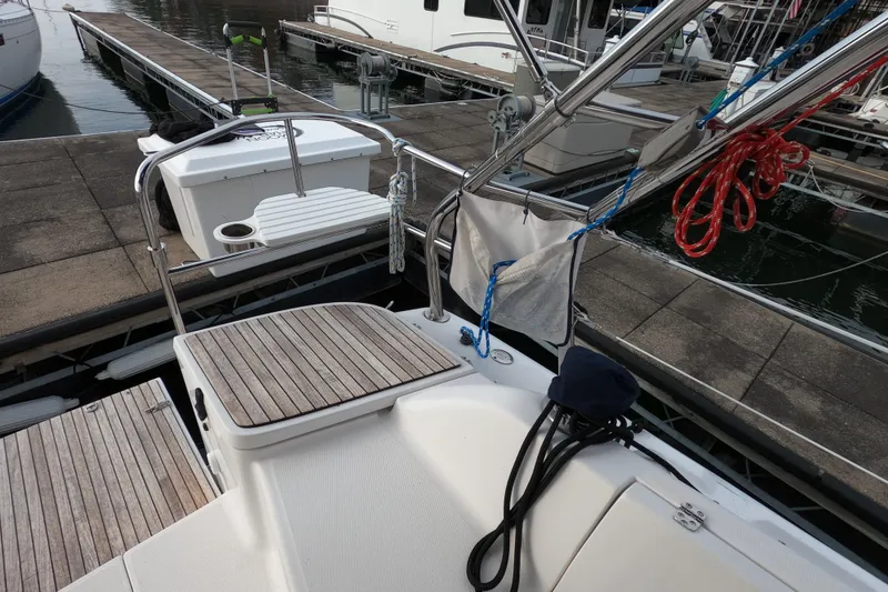 Slide: The Image of 2013 Marlow-Hunter e33 sailboat docked, featuring deck and marina view. - 14