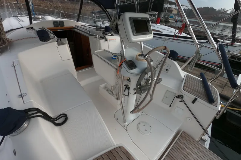 Slide: The Image of 2013 Marlow-Hunter e33 sailboat cockpit with steering wheel and navigation equipment. - 15