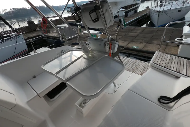 Slide: The Image of Cockpit of 2013 Marlow-Hunter e33 sailboat with folding table and marina view. - 17