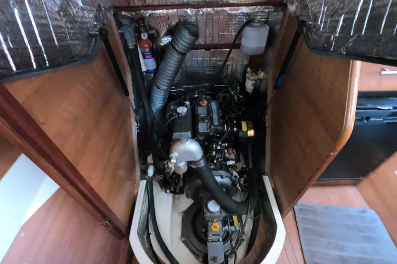 Slide: The Image of Engine compartment of a 2013 Marlow-Hunter e33 sailboat, showcasing mechanical components. - 21