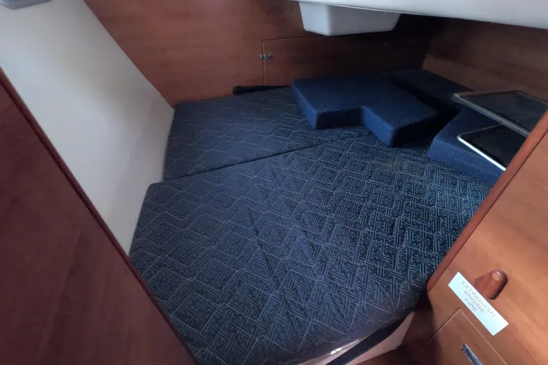 Slide: The Image of 2013 Marlow-Hunter e33 cabin interior with blue patterned cushions. - 25
