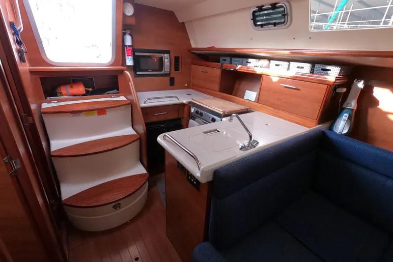 Slide: The Image of Interior of 2013 Marlow-Hunter e33 sailboat with kitchen and seating area. - 27