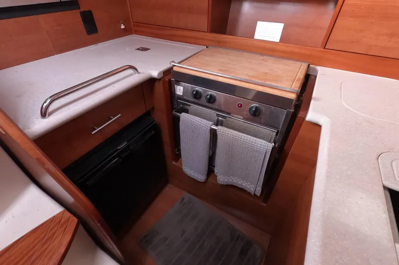 Slide: The Image of Compact kitchen area in a 2013 Marlow-Hunter e33 sailboat with stove and countertop. - 28