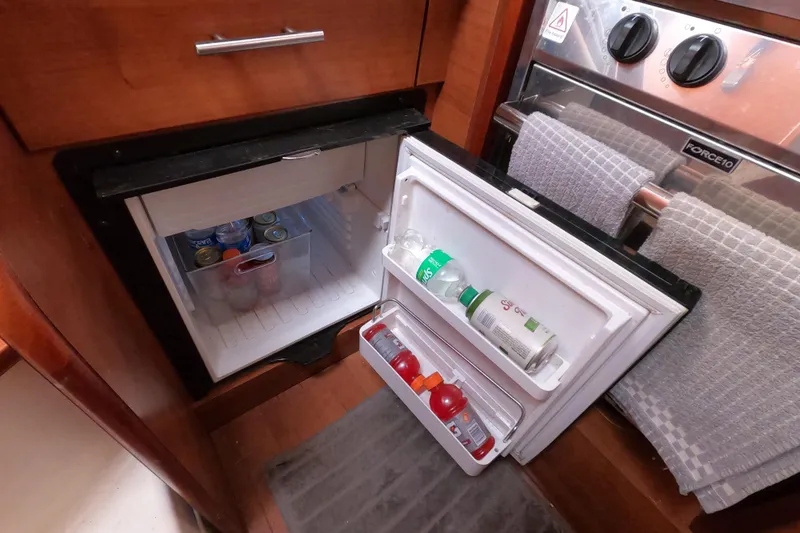Slide: The Image of Compact fridge in 2013 Marlow-Hunter e33 yacht galley, stocked with beverages. - 30