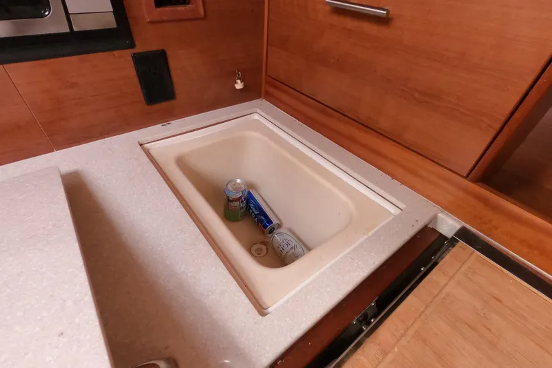 Slide: The Image of 2013 Marlow-Hunter e33 interior with built-in cooler and beverage cans. - 31