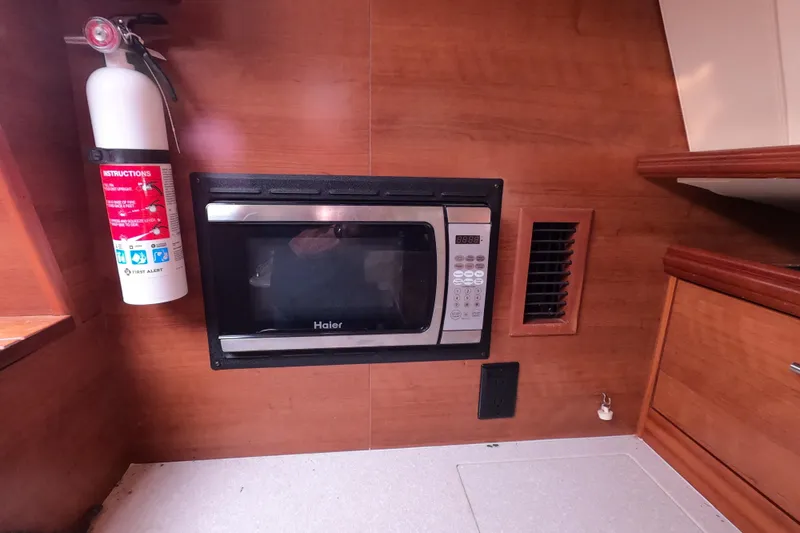 Slide: The Image of Fire extinguisher and microwave in 2013 Marlow-Hunter e33 yacht interior kitchen. - 33