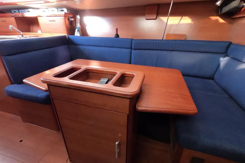 Slide: The Image of 2013 Marlow-Hunter e33 yacht interior with blue seating and wooden table. - 35