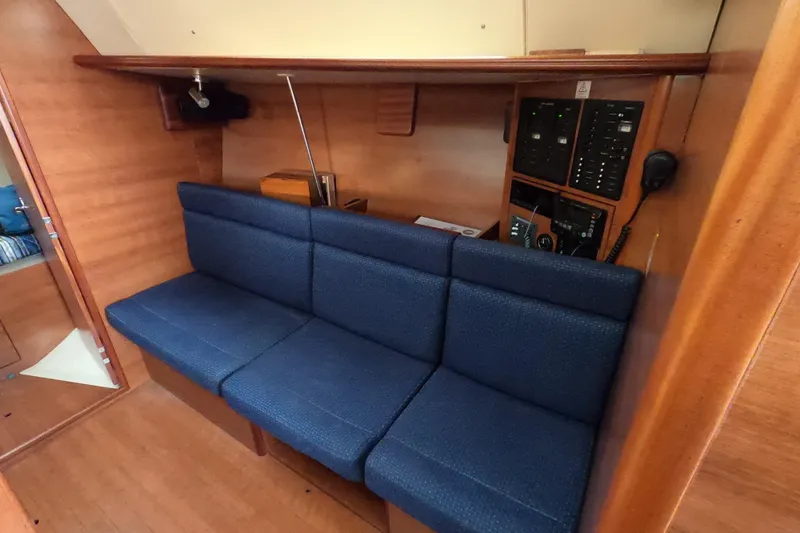 Slide: The Image of Interior of 2013 Marlow-Hunter e33 sailboat with blue seating and control panel. - 37