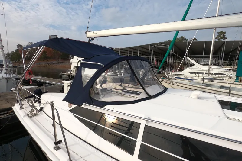 Slide: The Image of 2013 Marlow-Hunter e33 sailboat docked with blue canopy and clear windows. - 4