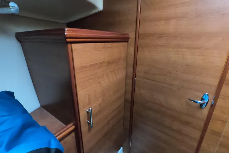 Slide: The Image of Interior of 2013 Marlow-Hunter e33 sailboat with wooden cabinetry and door. - 42