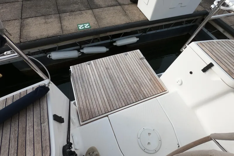 Slide: The Image of 2013 Marlow-Hunter e33 sailboat stern with teak decking at dock. - 6