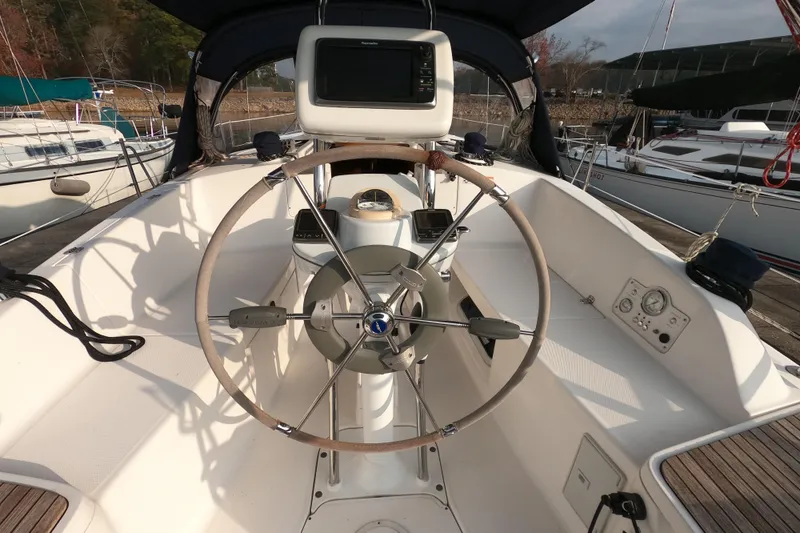 Slide: The Image of 2013 Marlow-Hunter e33 sailboat cockpit with steering wheel and navigation equipment. - 9