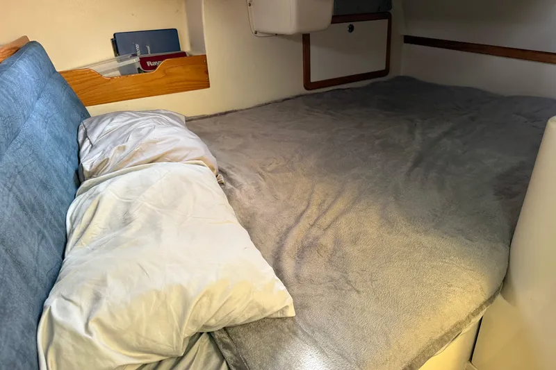 Slide: The Image of Cozy sleeping area in a 2000 Catalina 320 sailboat cabin with pillows and soft bedding. - 20