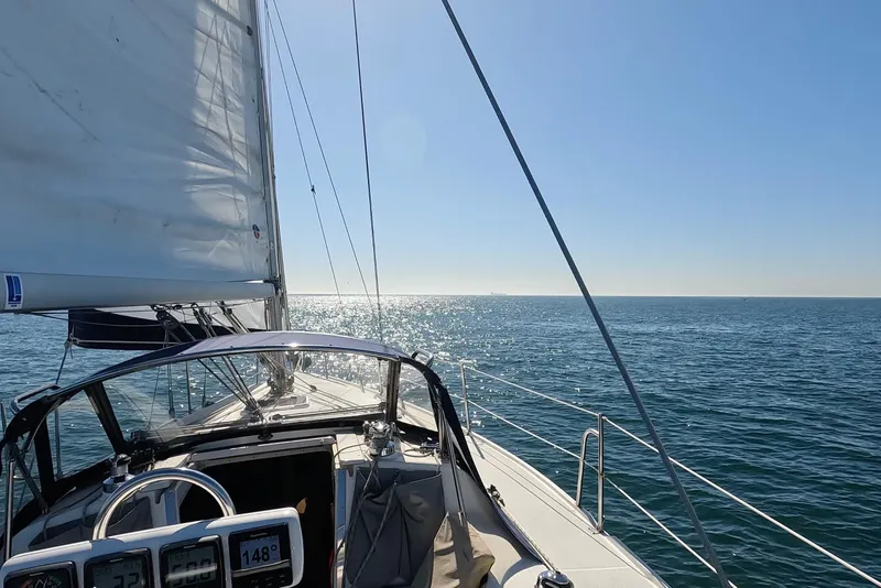 Slide: The Image of Sailing on a 2000 Catalina 320 yacht under clear blue skies and sparkling sea. - 24