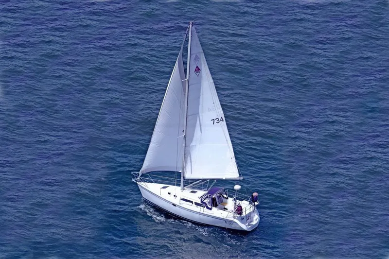Slide: The Image of Sailboat Catalina 320 (2000) cruising on open blue water. - 25