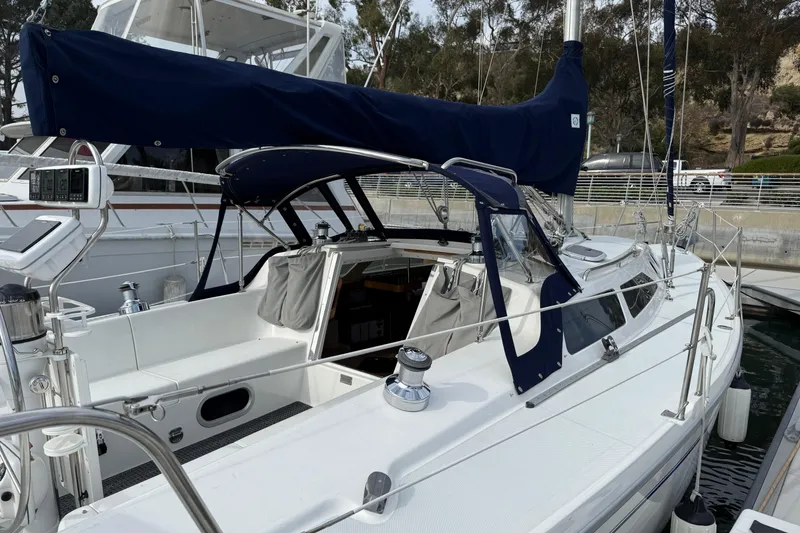 Slide: The Image of Catalina 320 sailboat, 2000 model, docked with blue canvas covers. - 3