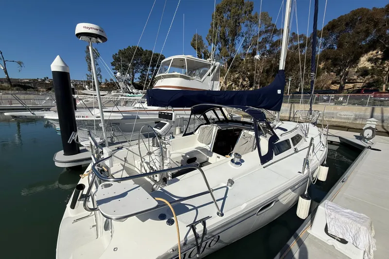 Slide: The Image of Catalina 320 sailboat from 2000 docked at a marina, featuring a sleek design. - 4