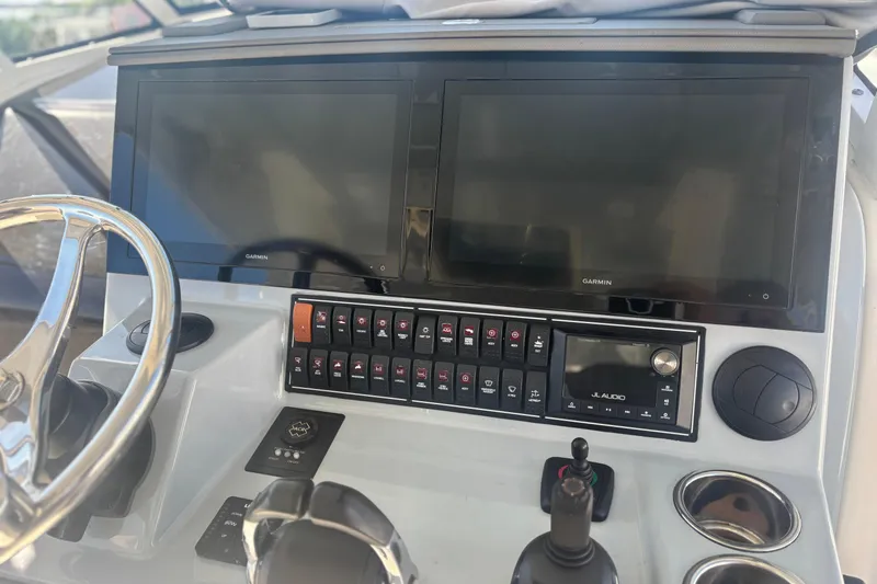 Slide: The Image of 2021 Pursuit S 378 Sport boat dashboard with Garmin displays and JL Audio system. - 10