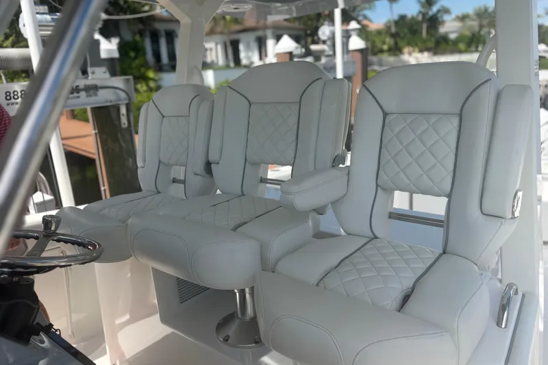 Slide: The Image of Luxurious seating on 2021 Pursuit S 378 Sport boat, featuring elegant white upholstery. - 11