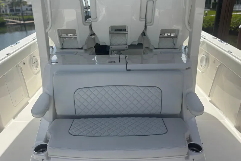 Slide: The Image of 2021 Pursuit S 378 Sport boat interior with cushioned seating and armrests. - 12