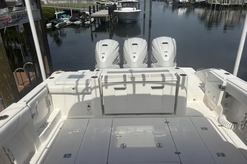 Slide: The Image of 2021 Pursuit S 378 Sport boat with triple V8 engines docked at marina. - 13